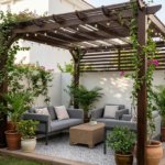 A stylish dark wood pergola installed in a small villa garden in Dubai, featuring a compact seating area with gray sofas, potted plants, and decorative string lights.