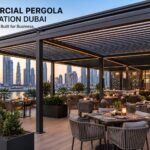 Modern commercial aluminum pergola installation in Dubai featuring outdoor restaurant seating with stylish shade structure and city skyline backdrop.